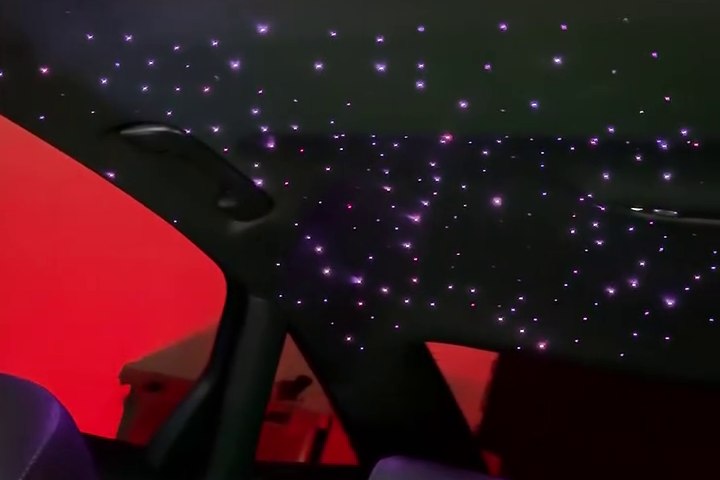 Purple starlights across a vehicle headliner